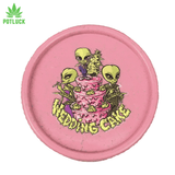 3 green aliens smoking herb on a pink wedding cake